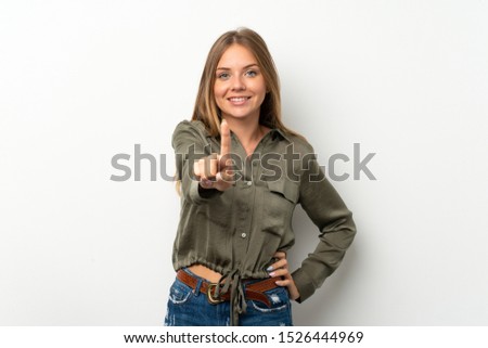 Lithuanian blonde girl over isolated white background showing and lifting a finger