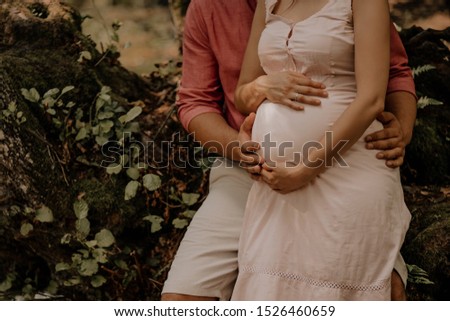 Romantic moments for pregnant couple in nature