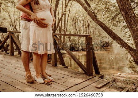 Romantic moments for pregnant couple in nature