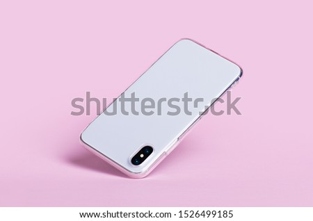 Smartphone in clear iPhone X silicone case falls down, back view. Phone case mockup