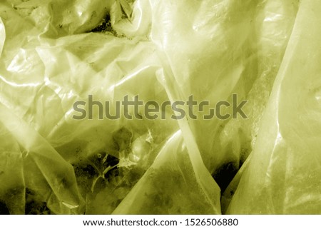 Plastic transparent old wrap texture in yellow tone. Abstract background and texture for design.