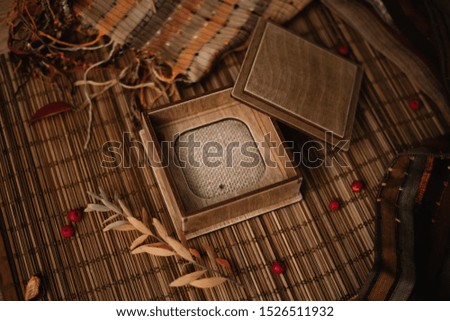 Autumn composition. Gift, autumn leaves and berries on wooden background. Flat lay, top view, copy space.