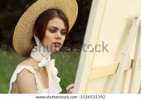 beautiful stylish young woman outdoors beautiful in hat draws