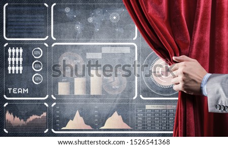 Hand opening red curtain and drawing business graphs and diagrams behind it