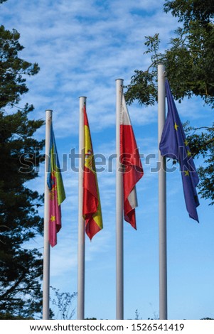 Four flags on masts over the sky