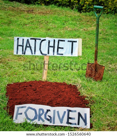 bury the hatchet - to forgive. this picture can be used to illustrate  Royalty-Free Stock Photo #1526560640