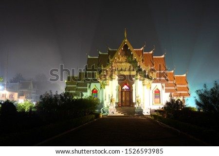 A wide shot of a Buddhist temple building in Bodhgaya, India. It is built in the style of a Thai temple