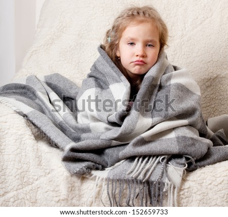 Illness child. Little girl wrapped in a blanket Royalty-Free Stock Photo #152659733
