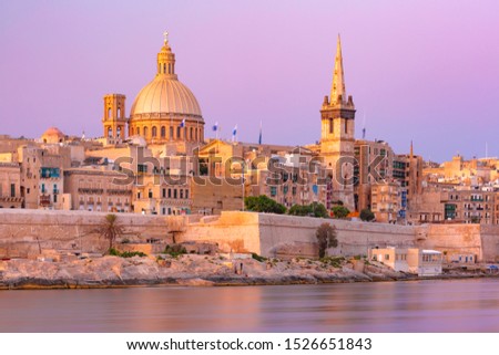 Valletta Skyline at beautiful sunset from Sliema with churches of Our Lady of Mount Carmel and St. Paul's Anglican Pro-Cathedral, Valletta, Capital city of Malta