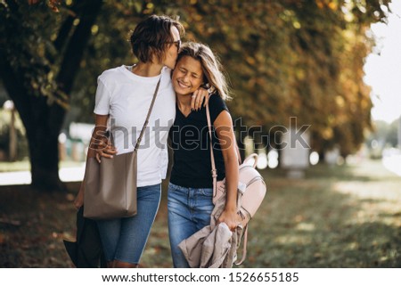 Young mother with daughter in autumn park