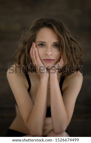 Beautiful and gentle girl posing with hands near face