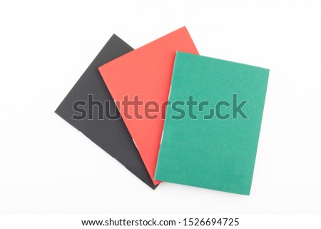 Empty notebook covers. Black, red and green booklets isolated on white background. 	Colorful paperback books. Royalty-Free Stock Photo #1526694725