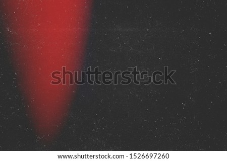 Red reflection on black background. Retro film photography effect. Analog foto. Frame. redaction. 90s. Lens flare and heavy grain texture. Capable Royalty-Free Stock Photo #1526697260