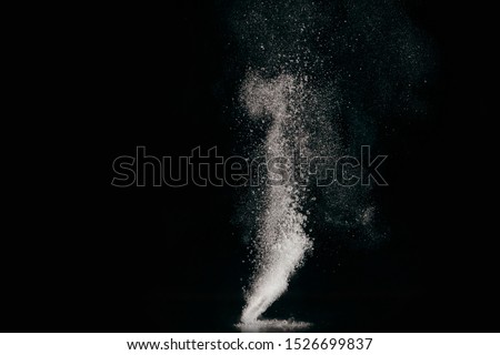 Tablet dissolving in water with bubbles on black background