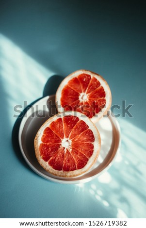 Red grapefruit halves on a plate