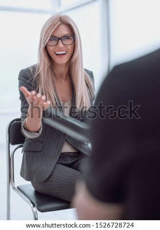 business woman answering questions during an interview.