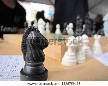 Knight in focus and other chess pieces in the background