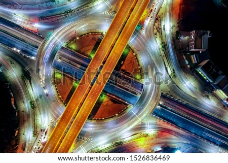 Aerial top view of smart modern transportation with Expressway, Road and Roundabout, busy highway traffic night time. Important infrastructure. Traffic center. For abstract background. Royalty-Free Stock Photo #1526836469