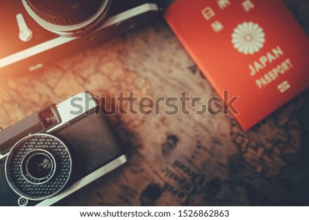 Vintage old camera, map and passport on wood table