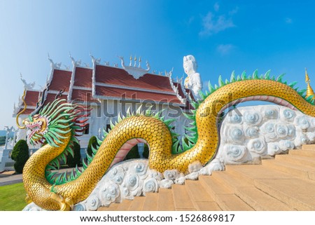 Beautiful Big White Guan Yin Statue and Golden Dragon at Wat Huay Pla Kang Buddhist Temple. Landmark of Chiang Rai. Located in Thailand. Picture for Chiang Rai Travel Concept.