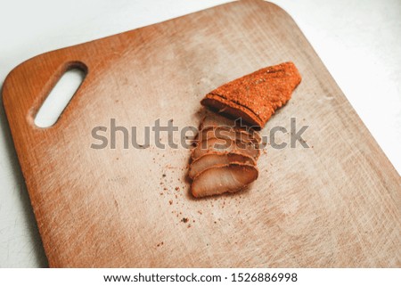basturma slices horse meat traditional Armenian food photography on wooden cutting board and white studio background with empty copy space for your text