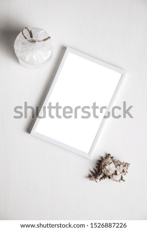 Photo frame with a white background decorated in a marine style.  White photo frame with shells with a place for your photo