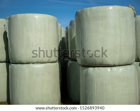 Runballs, hay bales wrapped in foil and stacked on top of each other for storage.