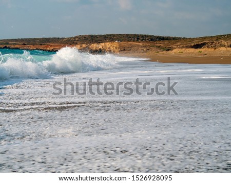 Foam and waves in the sea on a sunny day. Foam and waves in the sea. Powerful Waves crushing for background and desktop. Text box