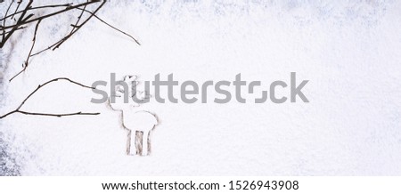 Christmas and holidays background. Silhouette of little deer in christmas snowfall. New Year is coming concept. Copy space and banner format.