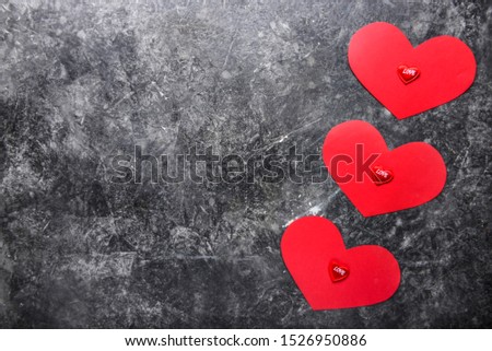 Red hearts on grey grunge background