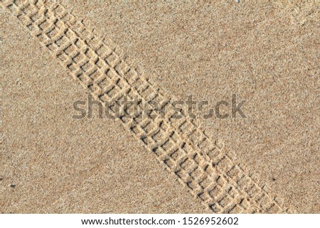 Bicycle tracks on a sand in summer, abstract background