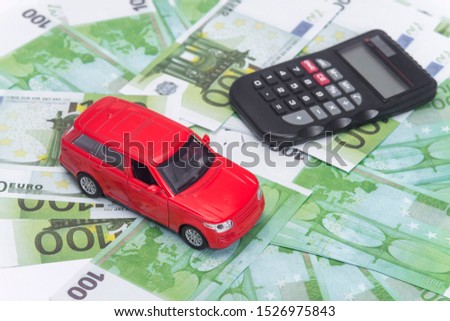 red car and money, euro and dollars. insurance concept