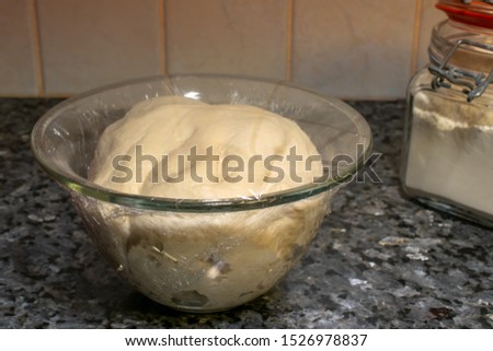 Bread dough in a glass bowl