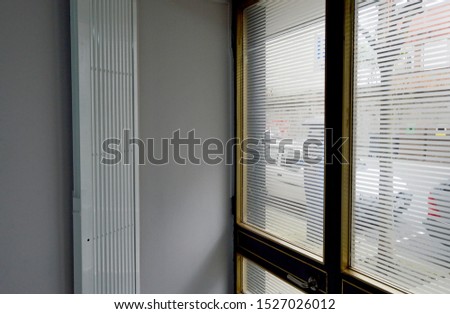 Glass and aluminum entrance door of an office premises in downtown city seen from inside