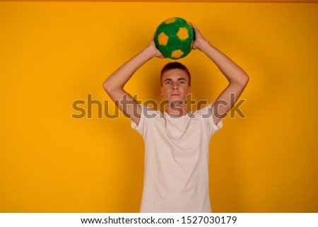 football player with ball on yellow background
