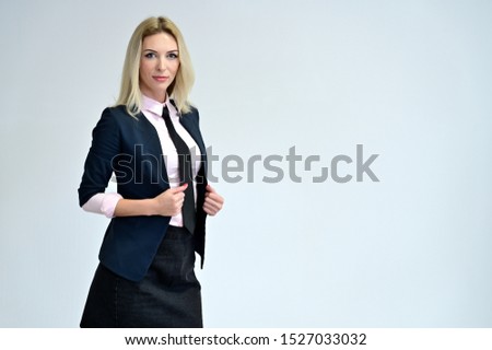 Studio portrait of a pretty blonde student girl with long hair in a jacket on a white background. Smiling at camera with emotions in various poses.