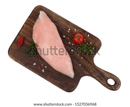 Raw turkey sirloin with a wooden board. White background. Isolated. Pack shot picture.