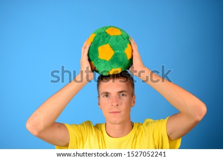 young man holds soccer ball over his head sport isolated background game