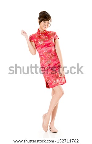 Smiling Chinese woman dress traditional cheongsam at New Year, studio shot isolated on white background.