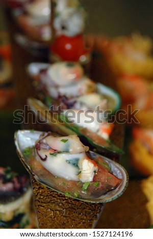A blurry photo with a festive delicacies made of scallops