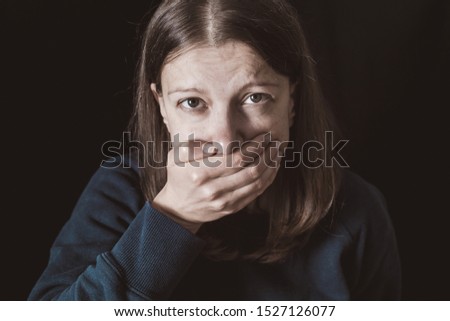 Woman with hands closed mouth. Female violence concept. Restriction and inability to speak.