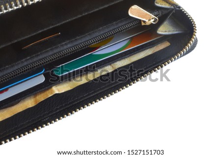 Top view of black genuine leather purse with bank notes Isolated on white background