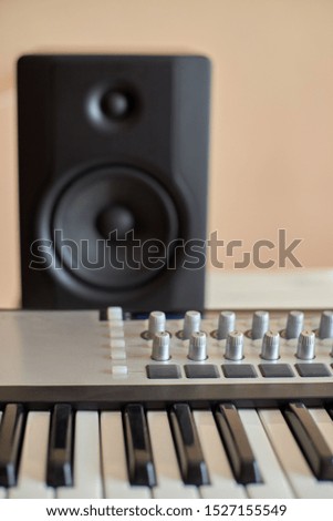 Master keyboard in the foreground and monitor in the background