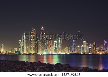 Landscape photo of water, stones and modern skyscrapers in Dubai Marina Royalty-Free Stock Photo #1527192815