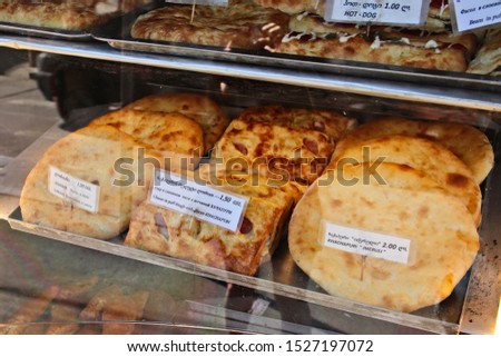 Khachapuri (Georgian flatbread made from dough, cheese and bacon) on display in a bakery. 