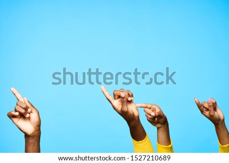 Male and female hands gesturing with fingers communication blue background