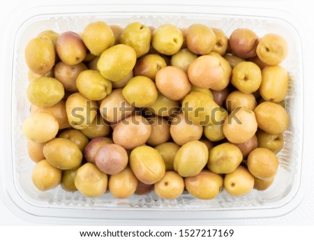 Pack of green olives. Top view Mediterannean cousine ingredient. Bowl of green olives isolated on white backgound Royalty-Free Stock Photo #1527217169