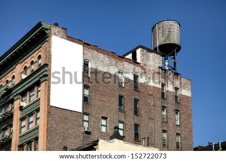 Big, white, blank, billboard on the brick building.