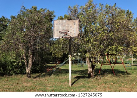 outdoor playground for children among the trees, basketball hoop