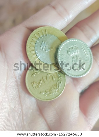 women holding coins on hands indian money 5 rs and 10 rs